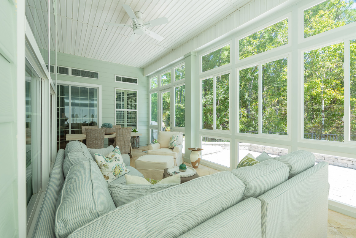 A beautiful sunroom design with white sofa inside 