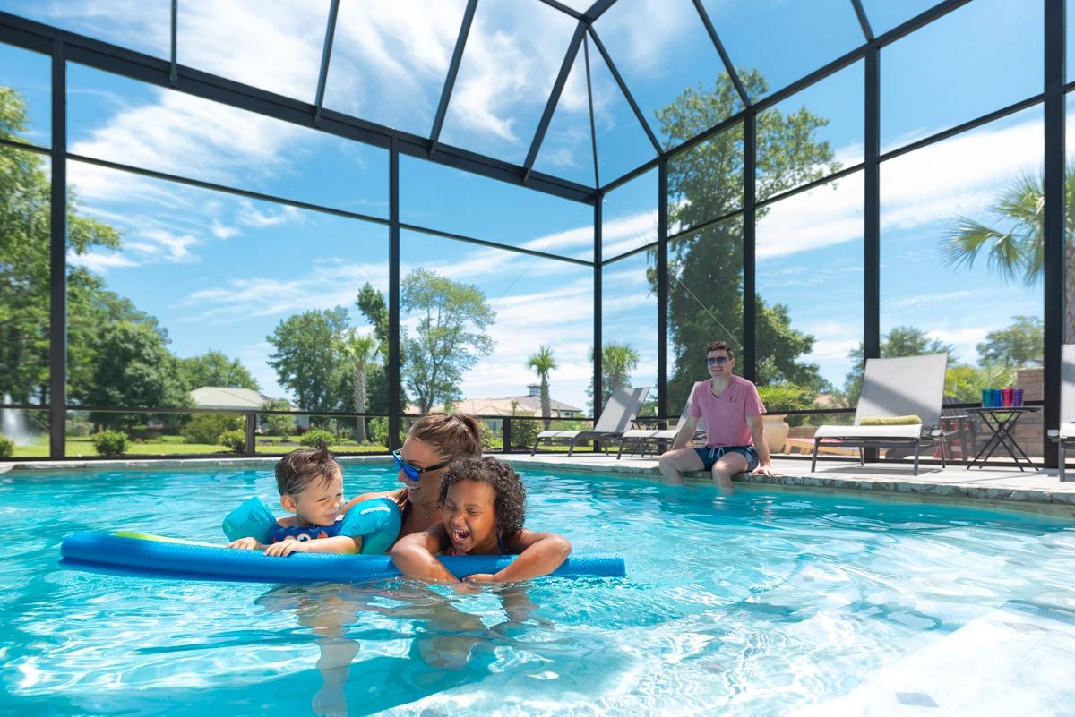 Image of two kids enjoying the weather in a pool enclosure in South Carolina 