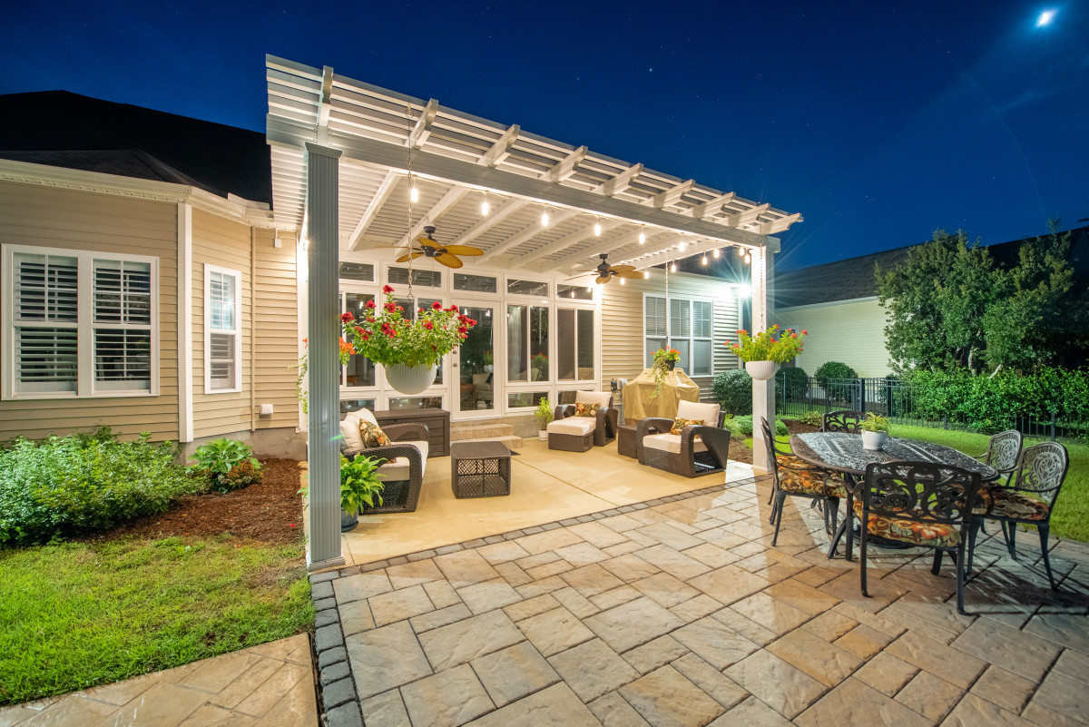 Locally crafted pergola, showcasing the skills of nearby contractors, with a natural wood finish and a classic design, enhancing the beauty of a suburban backyard.