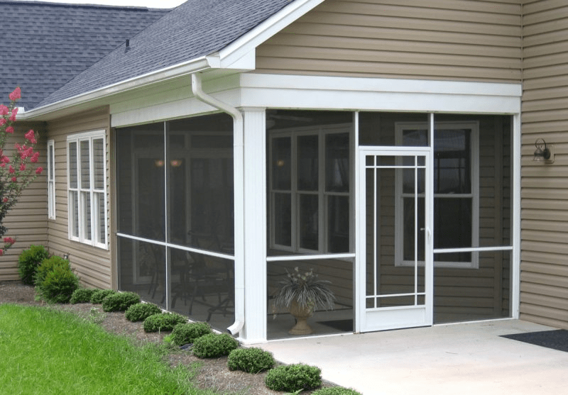 An image of a screen room on a home where the patio has been screened in 